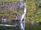  The guides on a zodiac shoot us as we shoot the waterfalls in Troll Fjord