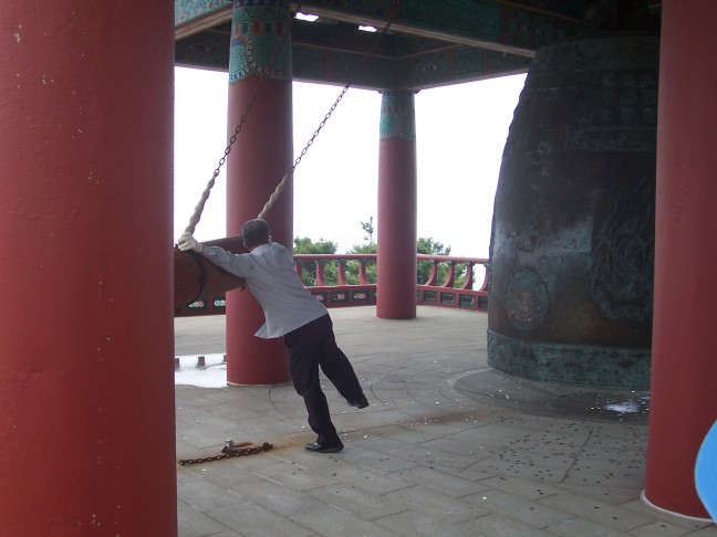 A monk at Seokguram Grotto does his gong bonging dance