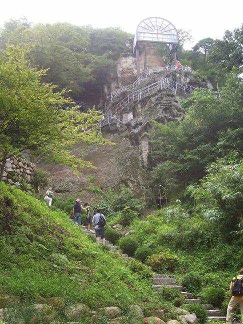 Our destination is the rock-hewn Buddha under the glass roof, far above.