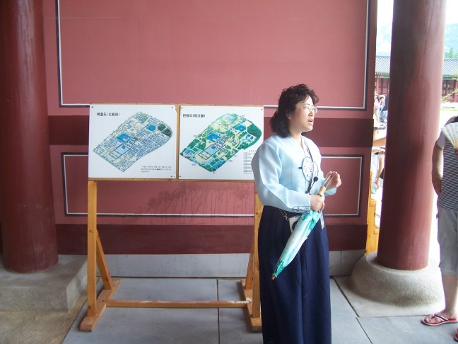 Out tour leader. The left diagram is all the buildings that used to ccupy the palace grounds. Now there are but a tenth--all restored. The Japanese burned everything in 1910.