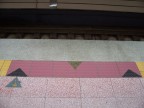  The platform edge has raised dots to warn the unsighted. The pink shows where a door will be. This is door 1 in car 2. There will be handicap seating on the left. Triangles tell debarkees to use the middle, while embarkees wait to the sides.