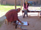  Anna explains while the Curandero builds a packet to burn for the healing ceremony, Cusco