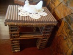  End table in paper house shows clearly how it is made from rolled newspapers; rolling was done with a hand-operated machine