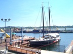  Modern tankers line the shore opposite the wooden antiques