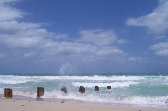 Windy beach with posts and clouds, Bal Harbour, Miami