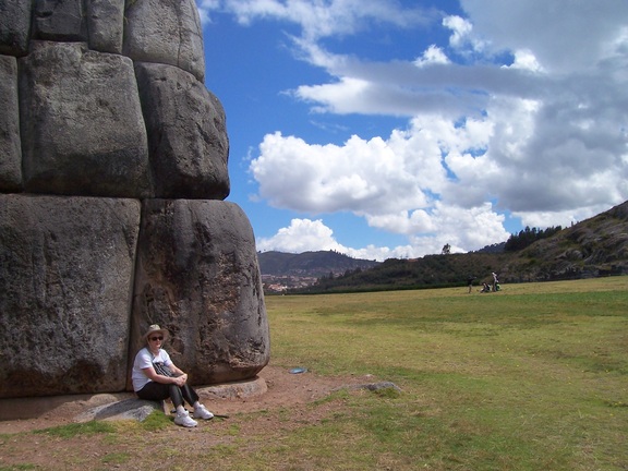 Susan shows the enormous scale of the tight-fitted Incan walls of Sacsayhuaman, Cusco