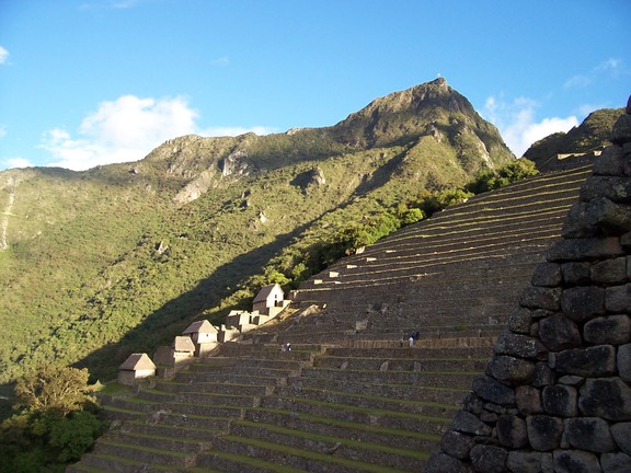 Machu Picchu itself is the mountain high above the agricultural terraces (the guardian hut sits atop the terraces)