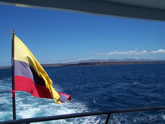 The civil flag of Ecuador seen astern as we head to Black Turtle Lagoon, Santa Cruz, Galapagos