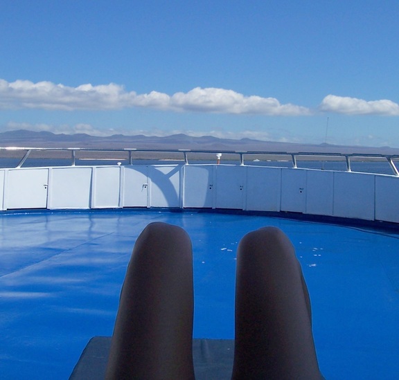 Leela contemplates the future across the bow of the Carina toward Santa Cruz, Galapagos