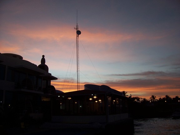 Satelite antenna for bank next door punctuates the sunset seen over our hotel, the Solymar, Puerto Ayora, Santa  Cruz, Galapagos