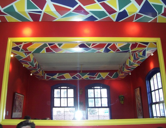 The Magic Bean restaurant has both a ceiling decoration and a huge mirror, Quito