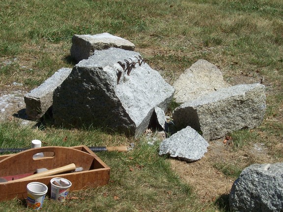 Demonstration of quarrying by pounding wedges into a row of small holes