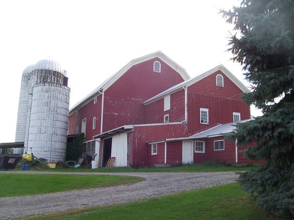 The farm's barn has grown, seemingly so fast its paint could not keep up