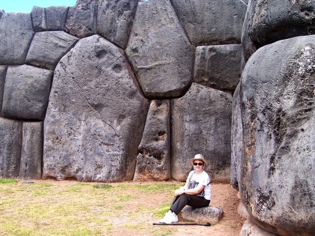 S is dwarfed by the mighty--yet tight-fitted--boulders at Sacsayhuaman, outside Cusco