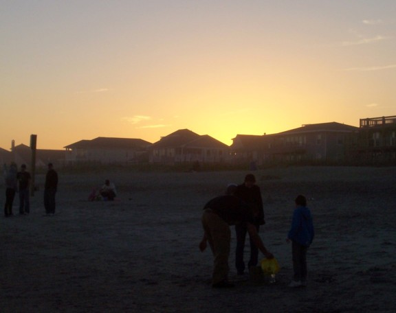 The sun sets behind beach houses at Wrightsville Beach