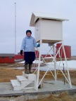  S balances on the steps of a weather observing device