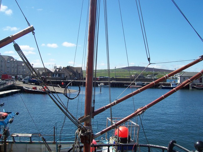 Kirkwall extends not far from the harbor. Beyond it the Orkneys are flattish.