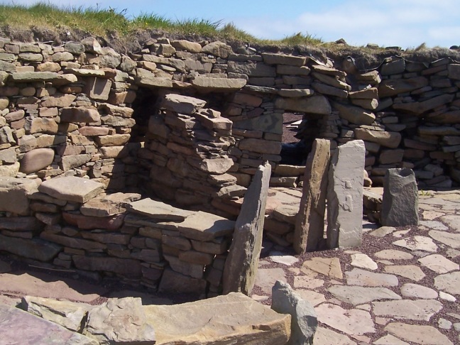 Standing stones guard the ends of the room divider piers at Scatness