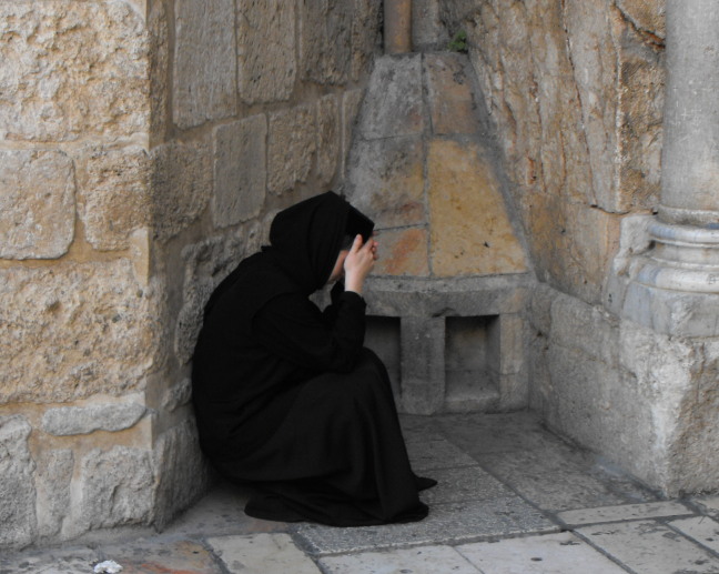  Nun praying at the entrance to the Church of the Holy Sepulchre