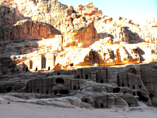  Sunlit dramatically separates the upper and lower tombs of the nobles, Petra