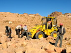  Workers manhandle unwanted rocks into a payloader, Petra