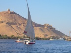  Felucca on the Nile with the Qubbet el-Hawa tombs, across the Nile from Aswan