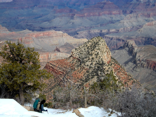  Intrepid hiker with two ski poles begins a planned six day hike on an icy trail