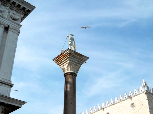  At the entrance to Piazza San Marco in Venice the lancer stands atop a pillar returned as spoils of the Crusades from Constantinople. The Doge's Palace is at the right.