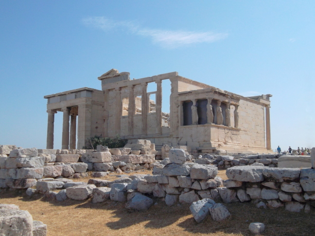  Erechtheion with the porch of the Caryatids. The Sacred Olive Tree left of center is supposedly descended from an original tree planted by Athena.