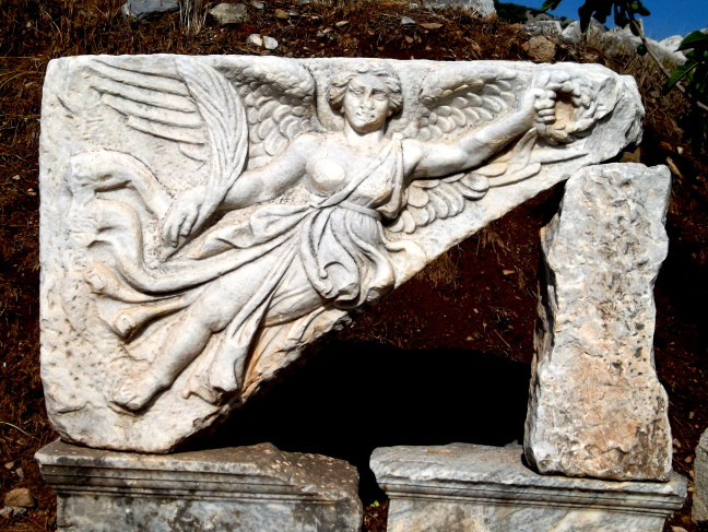  Nike, goddess of victory, is holding laurel leaves to bestow upon a winner in Ephesus
