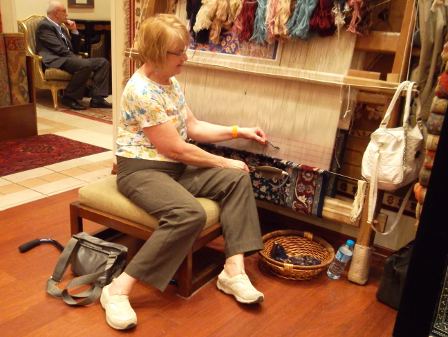  Susan adds a knot to a carpet at a shop in Istanbul