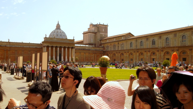 The Vatican Museum courtyard. Each of the signs is a station where a guide is explaining the Sistine Chapel.