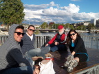  "Lawyer", "banker", "Fred", and "ad exec" share wine while Susan checks out  the Rousseau memorial  in the middle of a bridge over the lake in Geneva
