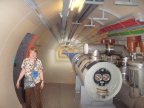  Here is Susan near an exhibit of a break in CERN&s LHC ring. The two brass discs that form the "eyes"   in  the end of the tube are the cross section of the two actual accelerator tubes,  one in each direction.  Particles travel in a penny-sized hole through these tubes.