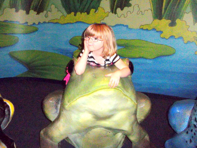  Lindsay rests with frog on lily pad at Cincinatti Children's Museum