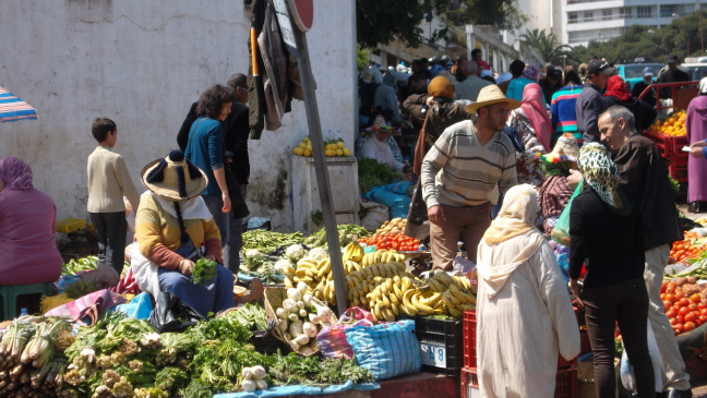  Vegetable market in Tangiers; shy Berber women in hats