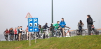  School chldren on bicycles touring windmills at Kinderdijk