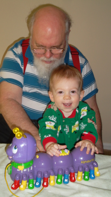 Grandpa shows the alphabet worm to Colin, but Colin looks elsewhere