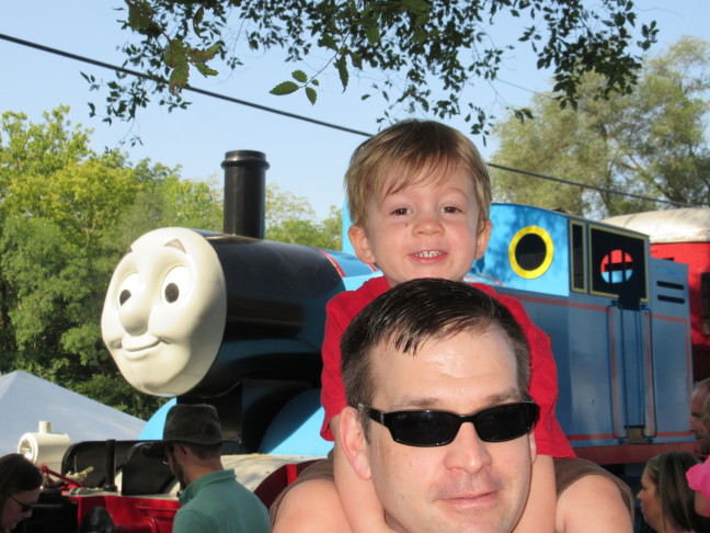 Daddy Derek gives Colin a piggy-back at the Thomas show