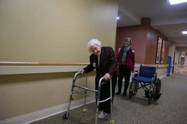 Mom stretching her legs in the corridor returning from supper