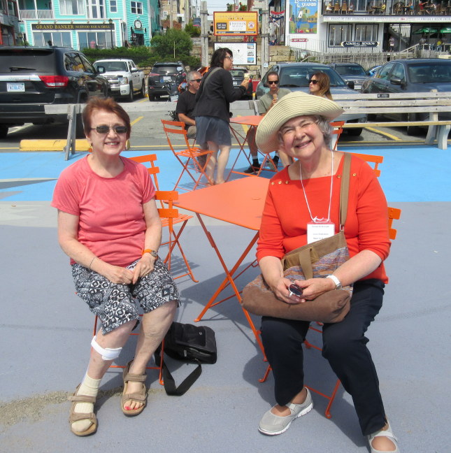 Study in orange, Susan and Joan on Lunenberg boardwalk