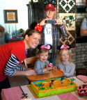  The whole family poses around the cake
